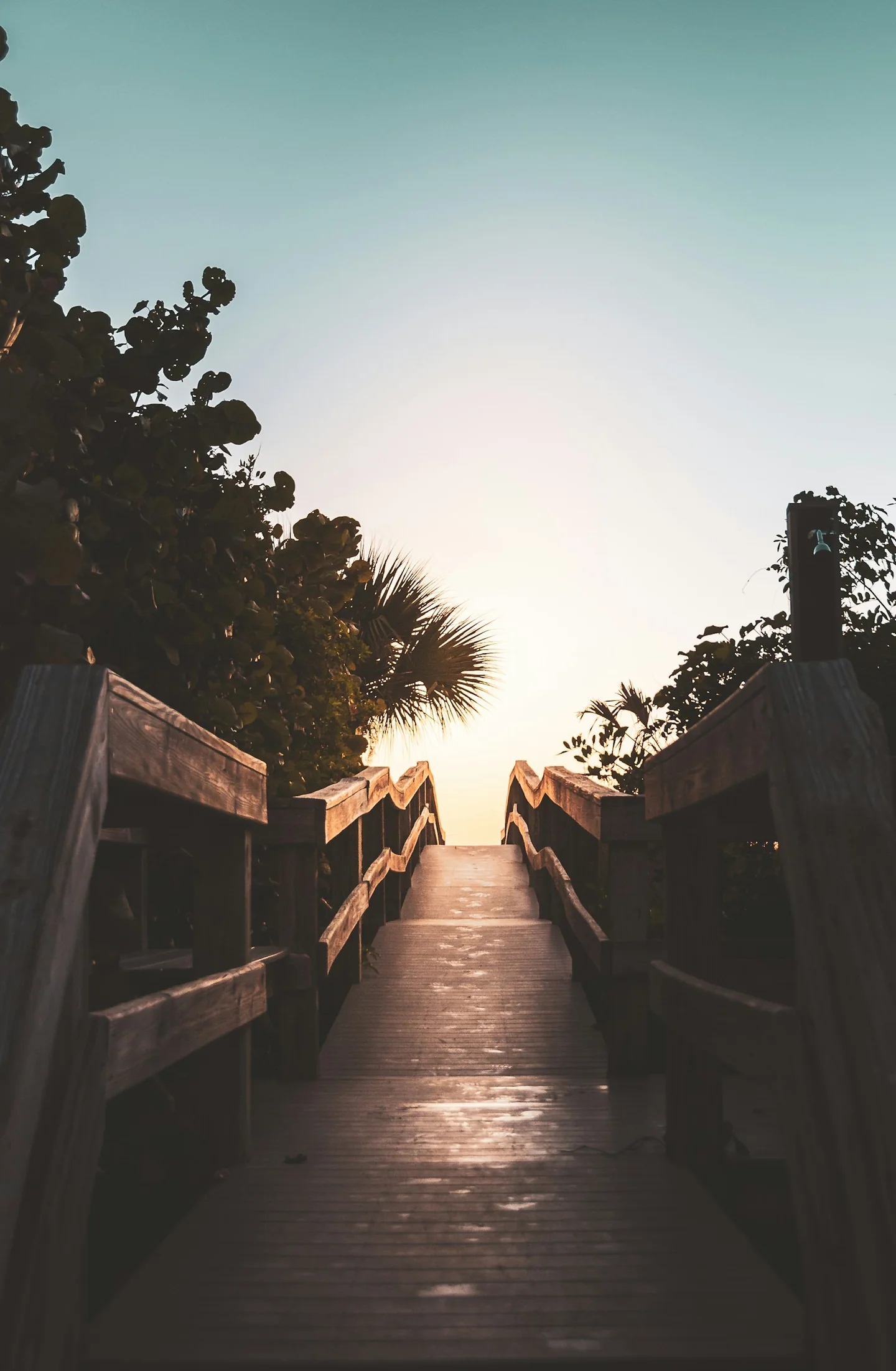 Wooden beach-access boardwalk at dawn in Cocoa Beach